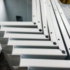 Fabricated metal pieces painted and powder coated white.