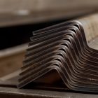 Closeup of formed and bended metal pieces stacked on top of each other