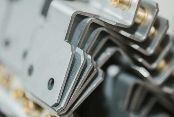 Closeup of several laser cut, formed, fabricated and assembled metal pieces